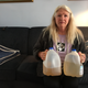 Gladyes Williamson holds up two water jugs full of water from the tap at her Flint home. Photo: Ryan Felton
